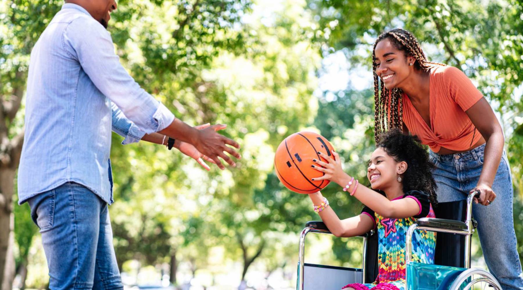 Girl in a wheelchair playing basketball