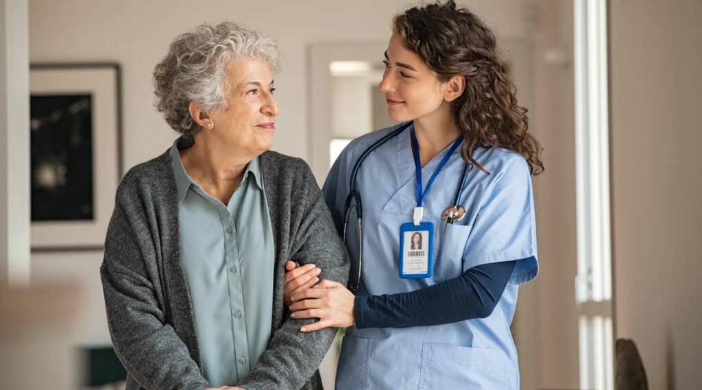 Nurse assisting her old woman patient at nursing home